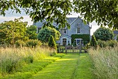WESTBROOK HOUSE, SOMERSET: OAK GATE, FENCE, PYRUS NIVALIS, SNOW PEAR TREES, COUNTRY, GARDEN, SUMMER, GRASS PATH, WILDFLOWERS, MEADOW