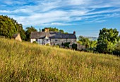 HURDLEY HALL, POWYS, WALES: CORONATION MEADOW IN FRONT OF 17TH CENTURY HALL, SUMMER, BORROWED LANDSCAPE