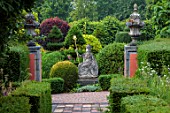 THE LASKETT GARDENS, HEREFORDSHIRE. DESIGNER ROY STRONG - THE SERPENTINE WALK - STATUE OF BRITANNIA, PATHS, CLIPPED, TOPIARY, BOX, HOLLY, ILEX, BUXUS, SUMMER, JULY