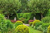 THE LASKETT GARDENS, HEREFORDSHIRE. DESIGNER ROY STRONG: VIEW ALONG GRASS PATH, STATUES, CLIPPED, TOPIARY, GREEN, GARDEN, VISTA, HEDGES, HEDGING, JULY, SUMMER