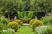 THE LASKETT GARDENS, HEREFORDSHIRE. DESIGNER ROY STRONG: VIEW ALONG GRASS PATH TO SHAKESPEARE MONUMENT, STATUES, CLIPPED, TOPIARY, GREEN, GARDEN, VISTA, HEDGES, HEDGING, JULY