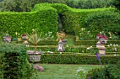 THE LASKETT GARDENS, HEREFORDSHIRE. DESIGNER ROY STRONG - THE SILVER JUBILEE GARDEN, SUNDIAL, BRICK PATH, URNS, CONTAINERS, BOX HEDGING, HEDGES, JULY, SUMMER