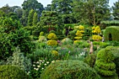 THE LASKETT GARDENS, HEREFORDSHIRE. DESIGNER ROY STRONG - THE SERPENTINE WALK - ACER GRISEUM, CLIPPED, TOPIARY, BOX, HOLLY, ILEX, BUXUS, JULY, SUMMER, YEW HEDGING