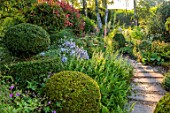 THE LASKETT GARDENS, HEREFORDSHIRE. DESIGNER ROY STRONG - BORDERS, PATHS, CLIPPED TOPIARY, SUMMER, JULY, SUNRISE, DAWN, SERPENTINE WALK