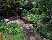 LOOKING DOWN ON GARDEN. PATH WITH INSET BLUE TILES LEADS TO WOODEN SEAT & RAISED BEDS. DES:KEEYLA MEADOWS. SAN FRANCISCO