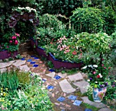 GARDEN WITH PATH INSET WITH BLUE TILES. PAINTED POT  RAISED BEDS BORDERS & COPPER ARCH.DES: KEEYLA MEADOWS.SAN FRANCISCO