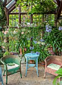 STOCKCROSS HOUSE, BERKSHIRE: CONSERVATORY, SUMMER, WICKER CHAIRS, TABLE, CONTAINERS, AGAPANTHUS, OLEANDER, PLUMBAGO