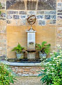 PRIVATE GARDEN, GLOUCESTERSHIRE - DESIGNER ANGEL COLLINS: WALL FOUNTAIN WITH FERNS, WATER, SPOUT, BORDER WITH AGASTACHE, MONARDA AND A DAHLIA, AUGUST