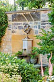 PRIVATE GARDEN, GLOUCESTERSHIRE - DESIGNER ANGEL COLLINS: WALL FOUNTAIN WITH FERNS, WATER, SPOUT, BORDER WITH AGASTACHE, MONARDA AND A DAHLIA, AUGUST