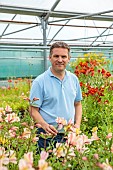 PRIMROSE HALL PEONIES, BEDFORDSHIRE: OWNER ALEC WHITE IN THE GREENHOUSE WITH HIS ALSTROEMERIA COLLECTION, SUMMER