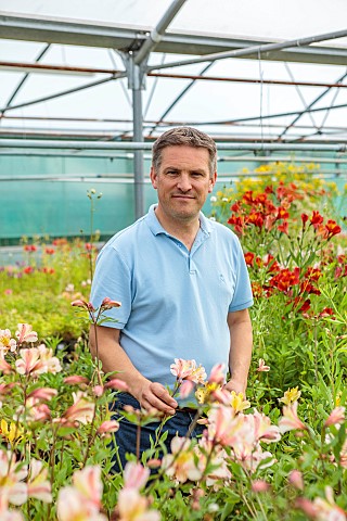 PRIMROSE_HALL_PEONIES_BEDFORDSHIRE_OWNER_ALEC_WHITE_IN_THE_GREENHOUSE_WITH_HIS_ALSTROEMERIA_COLLECTI