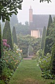 WOLLERTON OLD HALL, SHROPSHIRE:THE YEW WALK, GRASS, PATHS, PYRAMID, TOPIARY, MIST, FOG, SEPTEMBER, BORDERS