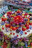ASHBROOK HOUSE, NORTHAMPTONSHIRE: DESIGNER JOSEPHINE MAYDON: DECORATIVE CAKE BY MATILDA, MATILDA CARR, GLOUCESTERSIRE, WITH FLOWERS AND FRUIT