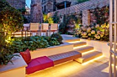 SMALL TOWN, CITY GARDEN DESGNED BY ALASDAIR CAMERON, LONDON: FORMAL, TOWN, GARDEN, NIGHT, LIGHTS, LIGHTING, STEPS, WOODEN BENCH, WALLS, HYDRANGEAS, TABLE, CHAIRS, OUTDOOR LIVING