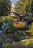 CHATSWORTH, DERBYSHIRE: DESIGN TOM STUART-SMITH: PAXTONS ROCK GARDEN WITH VIEW TO CHATSWORTH HOUSE BEYOND, SEPTEMBER