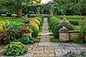 ROCKCLIFFE, GLOUCESTERSHIRE: PATH, LAWN, CLIPPED TOPIARY BOX, BUXUS, LAWN, TERRACE, STONE URNS, CONTAINERS, SEPTEMBER