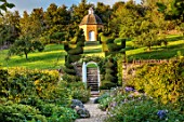 ROCKCLIFFE, GLOUCESTERSHIRE: AVENUE OF TOPIARY BIRDS LEADING TO DOVECOTE, GATE, STEPS, LAWN, PATHS, WALLS, GRASS, EVERGREENS, CLIPPED