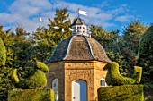 ROCKCLIFFE, GLOUCESTERSHIRE: THE DOVECOTE IN SEPTEMBER, CLIPPED TOPIARY YEW, CHICKENS, DOVES FLYING AWAY