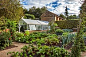 ROCKCLIFFE, GLOUCESTERSHIRE: POTAGER, VEGETABLE, KITCHEN, GARDEN, COUNTRY, HEDGES, HEDGING, PATH, ARCH, DAHLIAS, GREENHOUSE