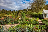 ROCKCLIFFE, GLOUCESTERSHIRE: POTAGER, VEGETABLE, KITCHEN, GARDEN, COUNTRY, HEDGES, HEDGING, PATH, ARCH, DAHLIAS, GREENHOUSE, DOVECOTE
