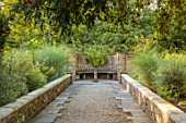 BOWCLIFFE HALL, YORKSHIRE: DESIGN ALISTAIR BALDWIN: PATH, STONE URN, CONTAINER, STONE BENCH, SEAT, MISCANTHUS MORNING LIGHT, SEPTEMBER, GRAVEL
