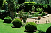THE ROUND BASIN SURROUNDED BY POTS ON THE LOWER TERRACE LA CASELLA  FRANCE. GARDEN DESIGNED BY CLAUS SCHEINERT