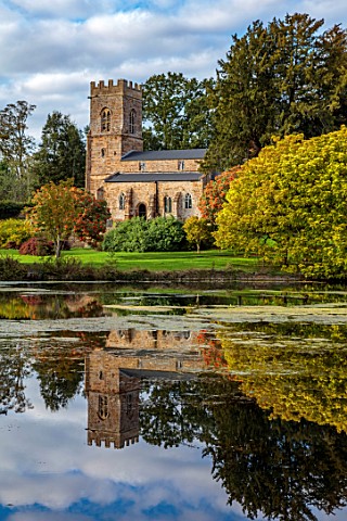 THENFORD_GARDENS__ARBORETUM_NORTHAMPTONSHIRE_REFLECTION_OF_CHURCH_ON_LAKE_POOL_POND_WATER_AUTUMN_CAT