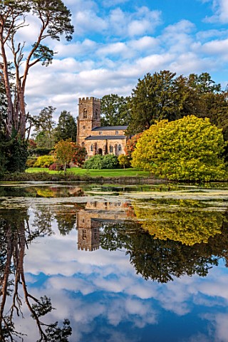 THENFORD_GARDENS__ARBORETUM_NORTHAMPTONSHIRE_REFLECTION_OF_CHURCH_ON_LAKE_POOL_POND_WATER_AUTUMN_CAT