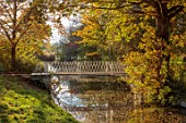 SPETCHLEY PARK GARDENS, WORCESTERSHIRE: WHITE METAL BRIDGE OVER THE CANAL, AUTUMN, OCTOBER, FALL, FOLIAGE, TREES, PARKLAND