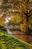 SPETCHLEY PARK GARDENS, WORCESTERSHIRE: WHITE METAL BRIDGE OVER THE CANAL, AUTUMN, OCTOBER, FALL, FOLIAGE, TREES, PARKLAND