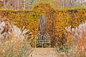 THE OLD RECTORY, QUINTON, NORTHAMPTONSHIRE: DESIGNER ANOUSHKA FEILER: GRASSES, AUTUMN, FALL, BEECH, HEDGE, HEDGING, PERENNIALS, WHITE METAL SEAT, BENCH, PATHS