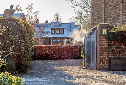 PRIORS_MARSTON_WARWICKSHIRE_THE_MANOR_HOUSE_FROST_SNOW_WINTER_DECEMBER_GATE_HEDGES_HEDGING_BEECH_CHI