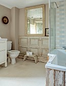 PEAR TREE COTTAGE, OXFORDSHIRE: BATHROOM, FRENCH PANELLED WALLS, WOOD FROM STABLE DOOR WITH BATH SURROUND, VINTAGE, FOXED GLASS FRENCH MIRROR, FRENCH CLOCK