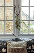 PEAR TREE COTTAGE, OXFORDSHIRE: SITTING ROOM, WIRE HEART WREATH, EUCALYPTUS, FRENCH CUSHIONS, VINTAGE GRAIN CLOTH