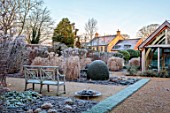 THE OLD RECTORY, QUINTON, NORTHAMPTONSHIRE: DESIGNER ANOUSHKA FEILER: GRASSES, FROST, WINTER, FROSTY GARDEN, ENGLISH, COUNTRY, JANUARY, SUMMERHOUSE, WOODEN BENCH, SEAT, BORDERS