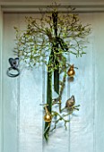 THE HYDE, HEREFORDSHIRE: JANUARY, CHRISTMAS DECORATIONS ON FRONT DOOR, BY SHANE CONNOLLY, METAL PARTRIDGE, PEARS, RIBBON, MISTLETOE