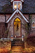 THE HYDE, HEREFORDSHIRE: WINTER, FROST, JANUARY, FRONT DOOR, STEPS, BRANCHES, MISTLETOE, METAL PEARS, PARTRIDGE, LIGHTS, LIGHTING