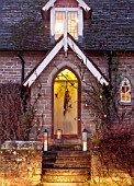 THE HYDE, HEREFORDSHIRE: WINTER, FROST, JANUARY, FRONT DOOR, STEPS, BRANCHES, MISTLETOE, METAL PEARS, PARTRIDGE, LIGHTS, LIGHTING