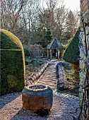 YORK GATE, LEEDS: THE CARPET PATH, STONE TROUGH, CONTAINER WITH IRIS RETICULATA GEORGE, PATH, FOLLY, FEBRUARY, WINTER