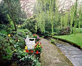 WEEPING WILLOW FRAMES VIEW OF WHITE PAINTED WOODEN SEAT BESIDE THE STREAM. MR & MRS STYLES GARDEN  OXON