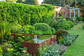 DESIGNER JAMES SCOTT, THE GARDEN COMPANY: WATER FEATURE, FOUNTAIN, METAL, SPRING, MAY, BORDER, YEW BALLS, LAWN, GREENHOUSE
