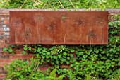 DESIGNER JAMES SCOTT, THE GARDEN COMPANY: RUSTY METAL PANEL WITH CUT OUT ALLIUMS ON WALL