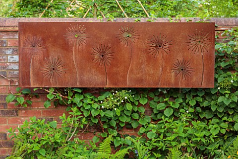 DESIGNER_JAMES_SCOTT_THE_GARDEN_COMPANY_RUSTY_METAL_PANEL_WITH_CUT_OUT_ALLIUMS_ON_WALL