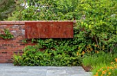 DESIGNER JAMES SCOTT, THE GARDEN COMPANY: PATIO, PAVING, GEUM TOTALLY TANGERINE, WALLS, METAL ORNAMENT WITH CUT OUT ALLIUMS