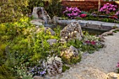 CHELSEA 2022: A SWISS SANCTUARY BY LILLY GOMM: PATH, ALPINE PLANTING, ROCKS, WATERFALL, RHODODENDRONS, METAL SEAT, POOL, POND, WATER