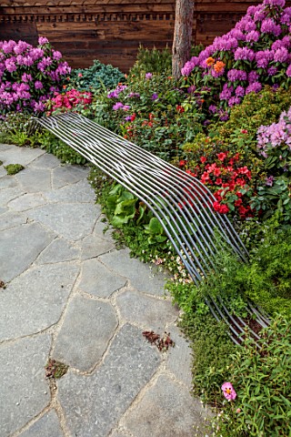 CHELSEA_2022_A_SWISS_SANCTUARY_BY_LILLY_GOMM_PATIO_SMETAL_SEAT_BENCH_RHODODENDRONS