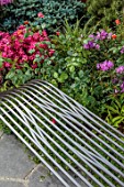 CHELSEA 2022: A SWISS SANCTUARY BY LILLY GOMM: METAL SEAT, BENCH, RHODODENDRONS, ROSA WESTERLAND
