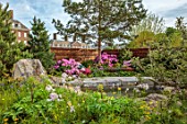 CHELSEA 2022: A SWISS SANCTUARY BY LILLY GOMM: ROCKS, WATERFALL, RHODODENDRON, FENCE, FENCING, PINE, ALPINE PLANTI NG, POND, POOL