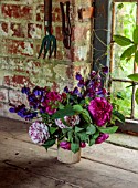 THE FLOWER GARDEN AT STOKESAY COURT, SHROPSHIRE: THE BOTHY, VASE, CONTAINER WITH ROSES, SWEET PEAS, ROSES, ROSA CHARLES DE MILLS, ROSA VARIEGATA DE BOLOGNA
