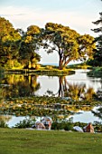 ENCOMBE HOUSE, DORSET: WATER, LAKE, WATERLILIES, BORROWED LANDSCAPE, TREES, LAWNS, REFLECTIONS, REFLECTED